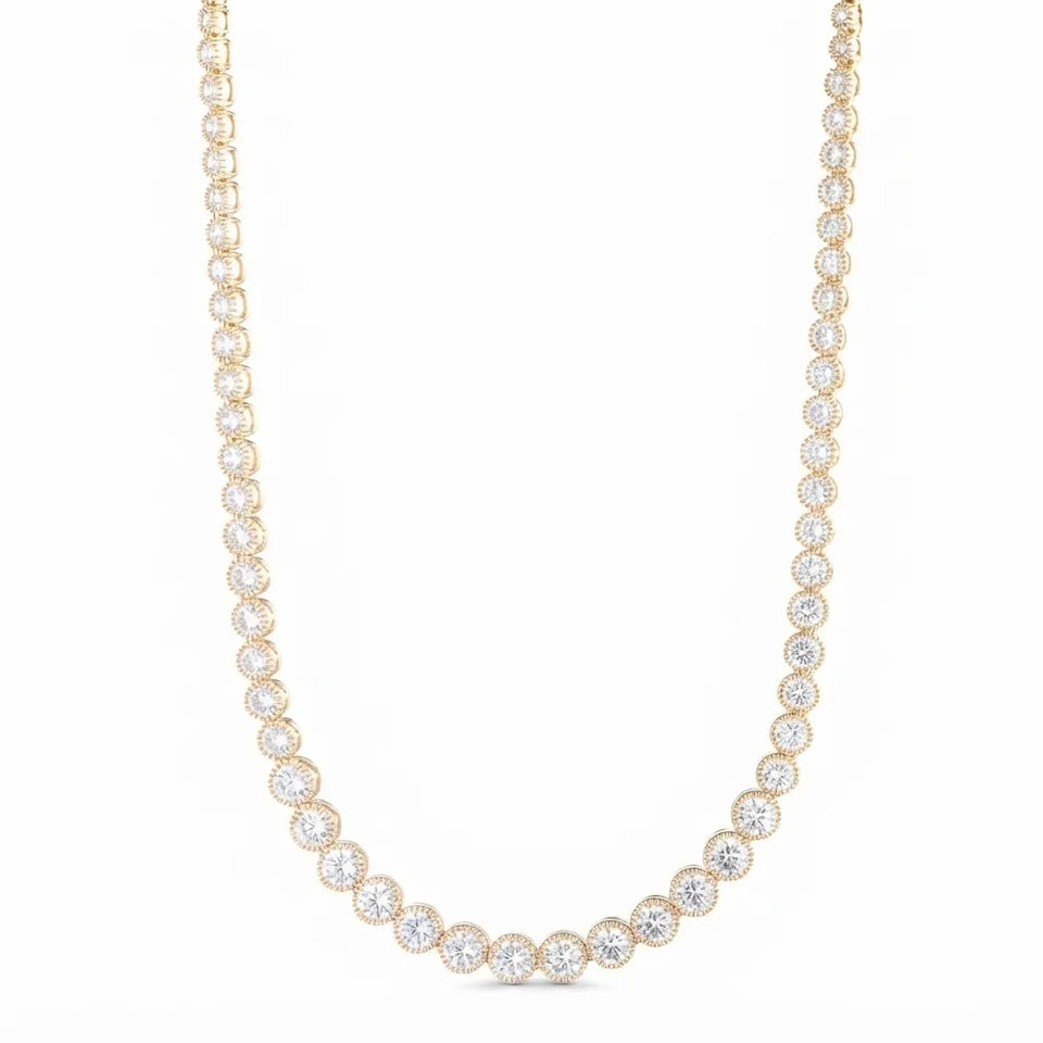 A yellow gold tennis necklace featuring round-cut clear gemstones in a halo setting, arranged in a U-shape against a solid white background.