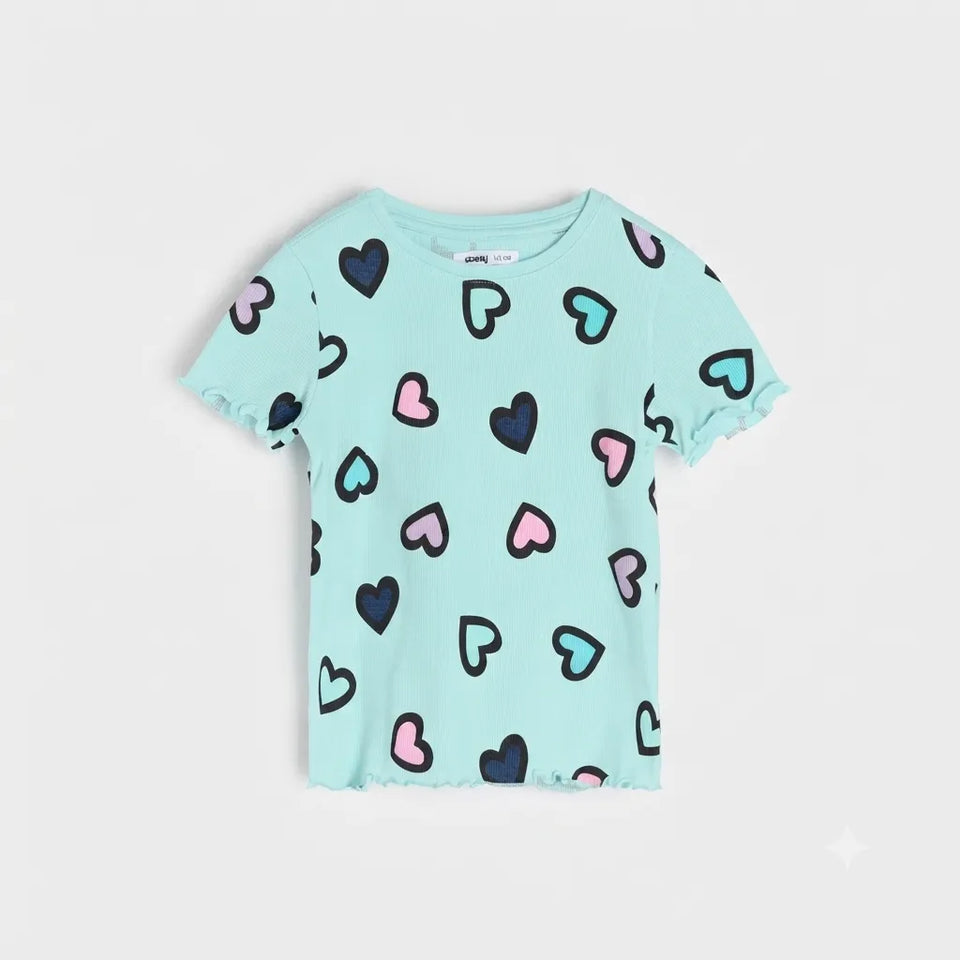 A light blue short-sleeve baby tee with a ruffled hem and cuffs, featuring an all-over pattern of hand-drawn hearts in black, pink, and light blue.