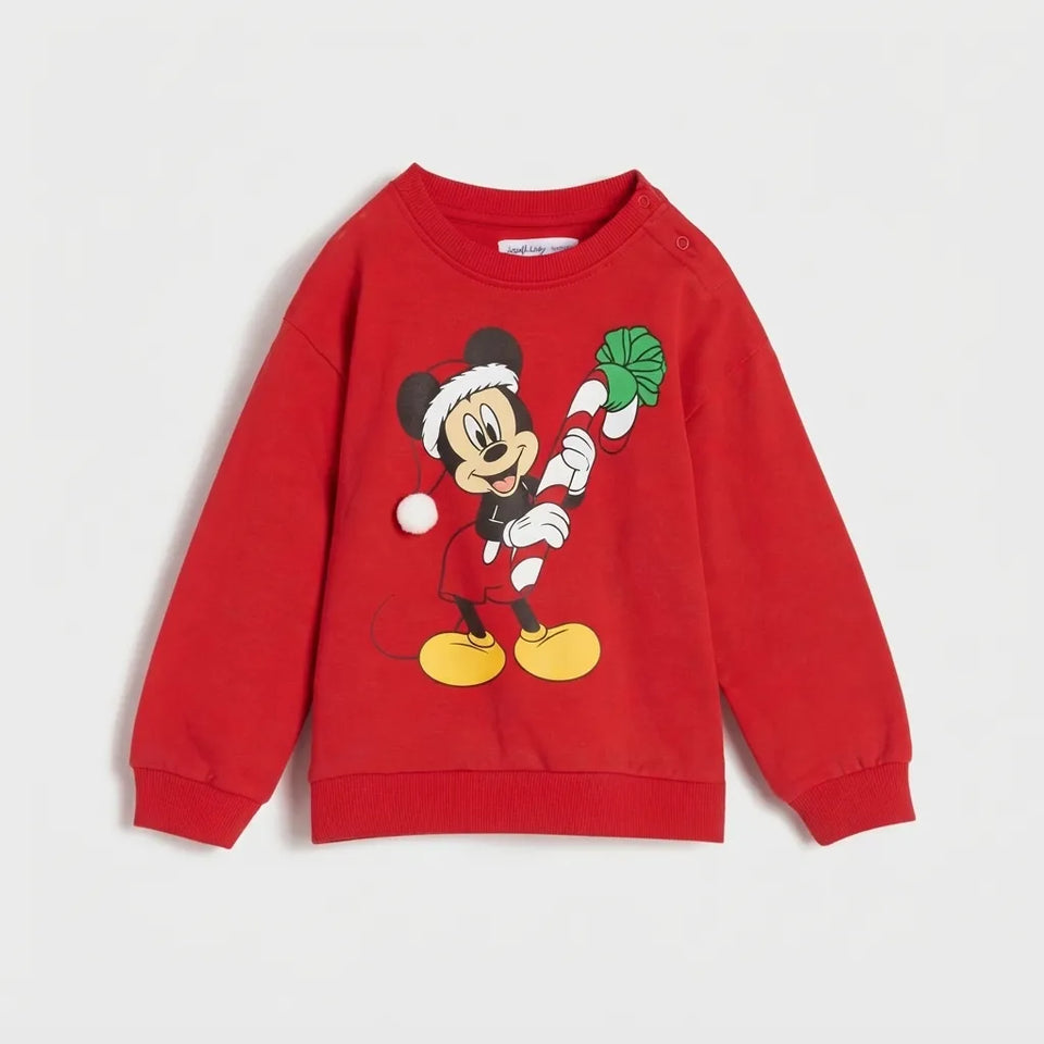 A red long-sleeve crewneck sweatshirt featuring a large graphic of Mickey Mouse dressed in a Santa hat and holding a candy cane, shown on a light gray background.