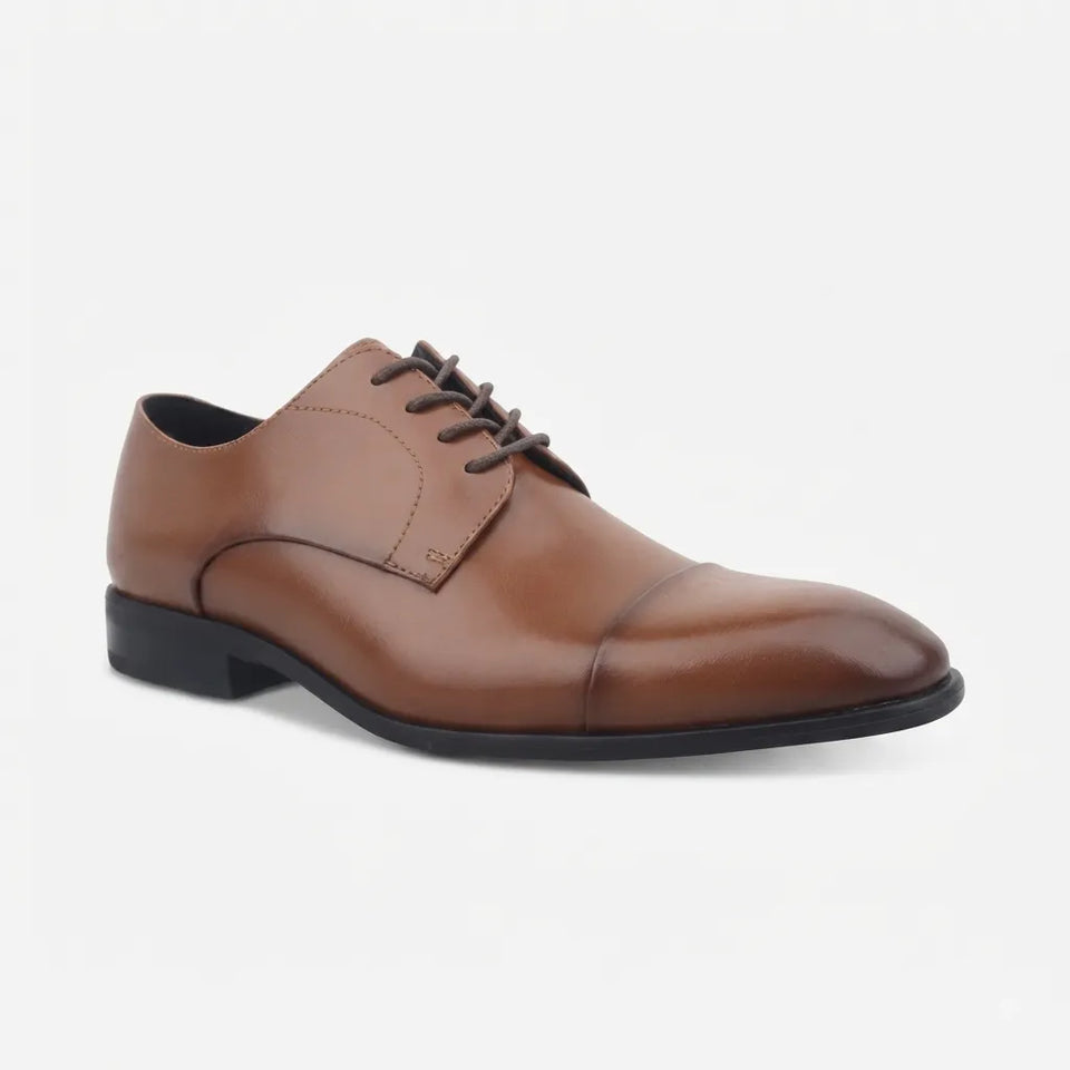 A classic men's brown leather oxford shoe with a cap toe, dark brown laces, and a black sole, shown from a three-quarters angle on a light gray background.