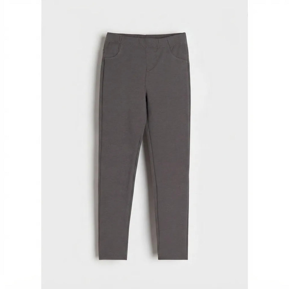 A pair of dark gray slim-fit leggings shown flat against a light gray background.