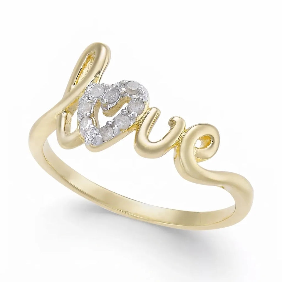 A yellow gold ring featuring the word 'love' in cursive script, with a small heart-shaped cluster of clear pavé stones at the center, shown on a white background.