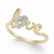 A yellow gold ring featuring the word 'love' in cursive script, with a small heart-shaped cluster of clear pavé stones at the center, shown on a white background.