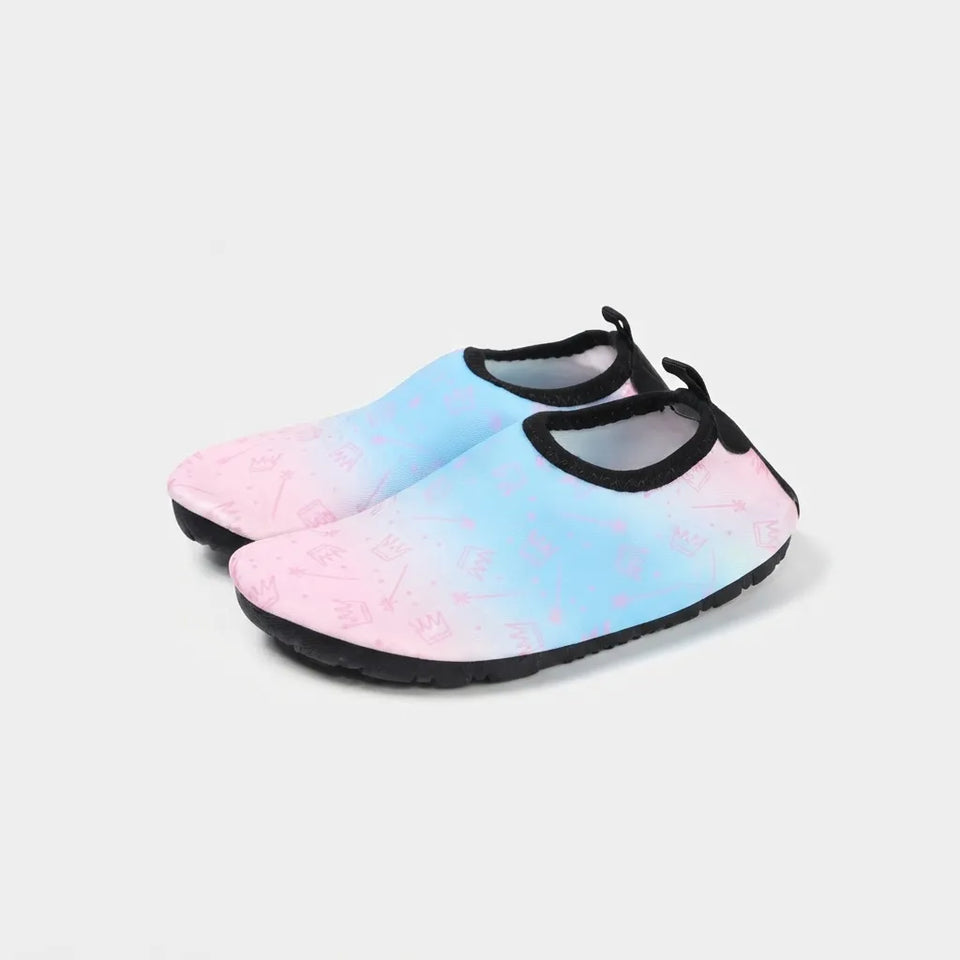 A pair of slip-on water shoes with a pastel blue and pink ombre gradient upper, featuring a subtle pink pattern and black trim and sole, shown on a light gray background.