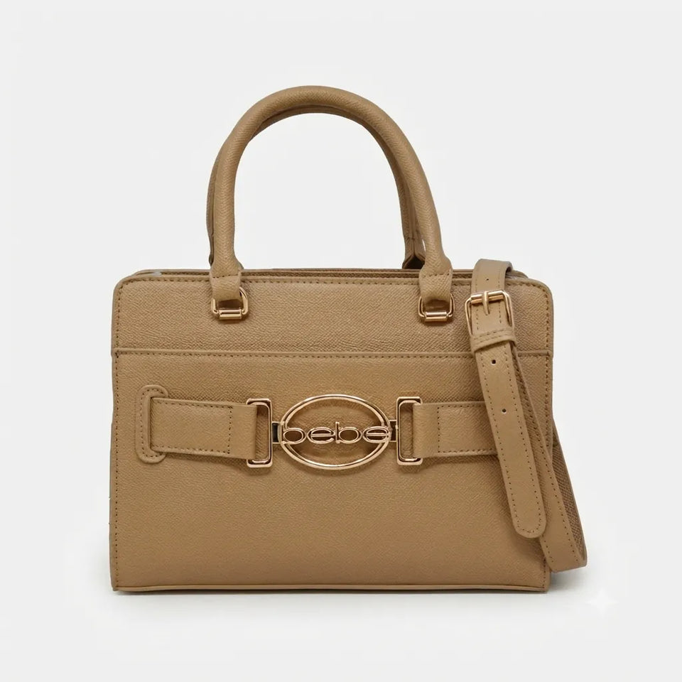 A structured tan leather handbag with top handles, a matching shoulder strap, and a decorative front strap featuring a prominent oval logo clasp that reads 'bebe'.