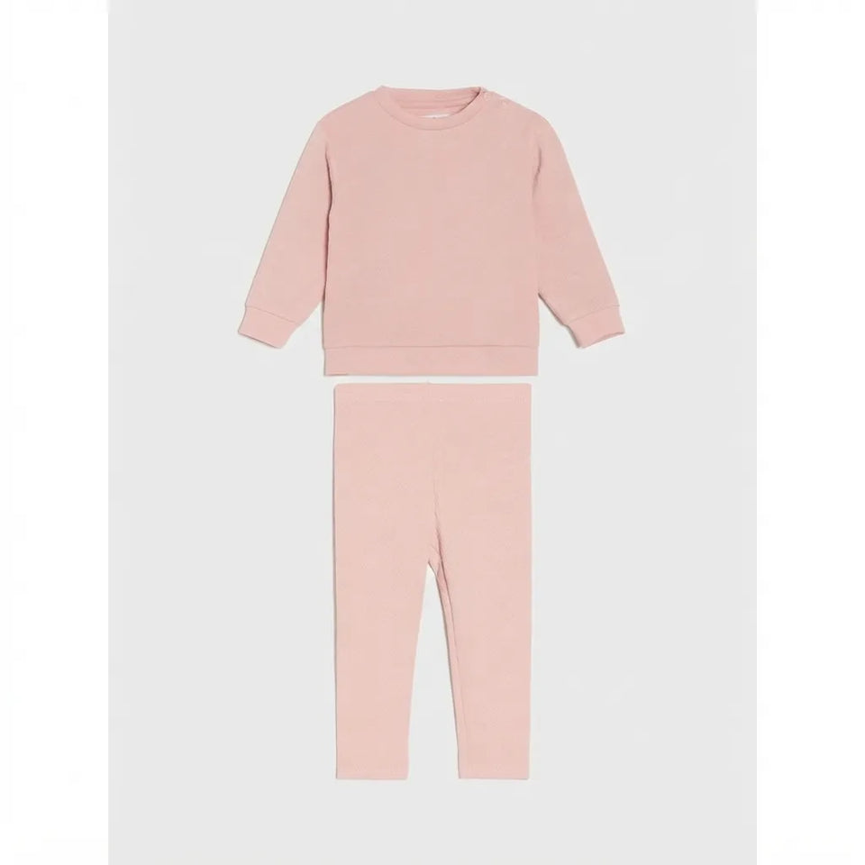 A two-piece children's loungewear set in a soft dusty pink color, featuring a long-sleeve crewneck sweatshirt and matching leggings, displayed flat against a light gray background.