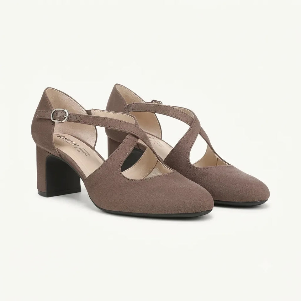 A pair of women's block-heel Mary Jane shoes in taupe brown suede, featuring criss-cross straps and a small silver buckle on the ankle strap, shown against a plain off-white background.