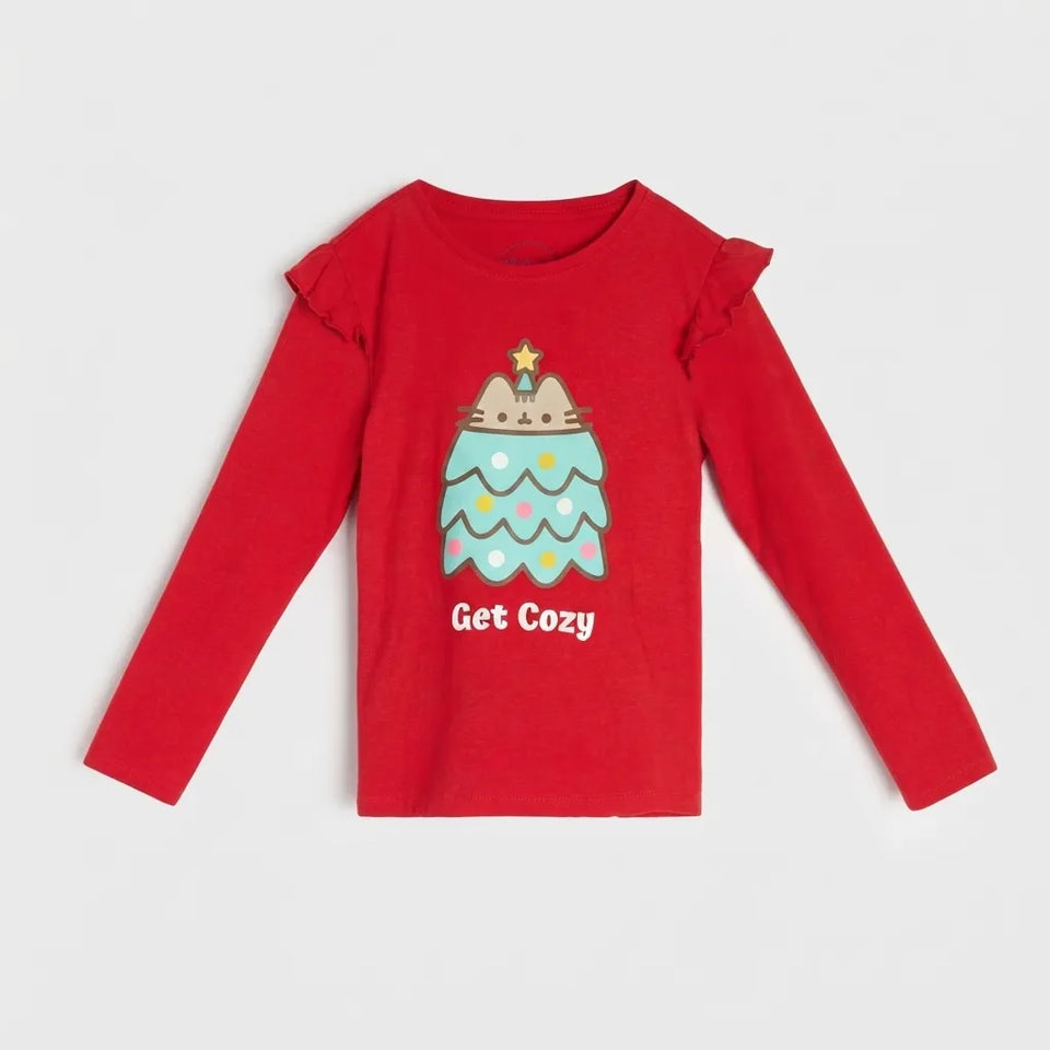 A red long-sleeve children's top with ruffled shoulder details, featuring a cute illustrated Christmas tree graphic and the text 'Get Cozy' printed on the front, displayed against a light gray background.