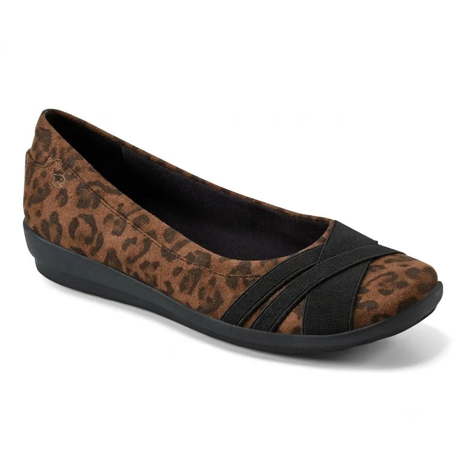 A single women's flat shoe with a brown and black leopard print upper, black crisscross elastic straps across the toe, and a black wedge sole, shown on a white background.