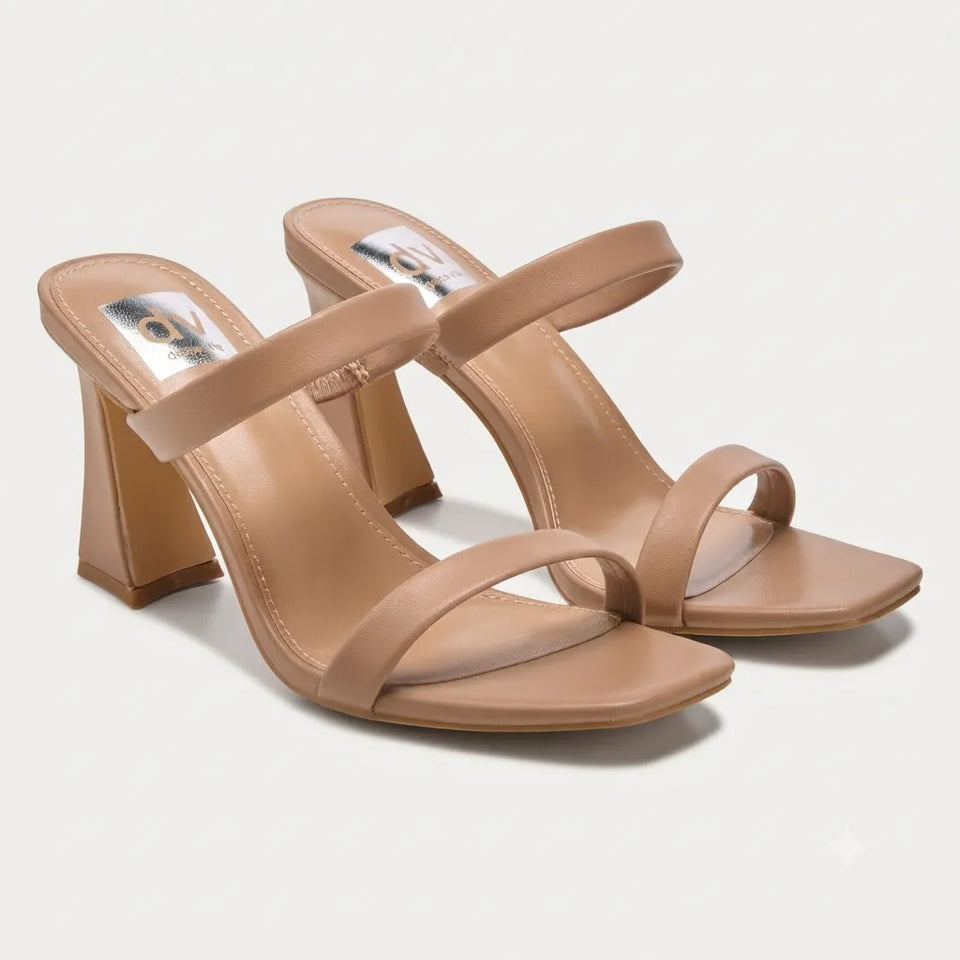 A pair of women's block-heel mule sandals in a light tan or nude color, featuring a square toe and a double-strap design, shown on a light gray background.