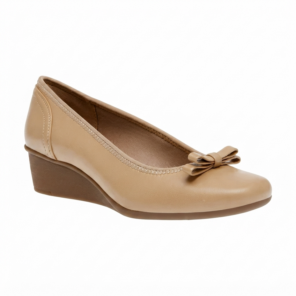 A single beige leather wedge pump shoe with a small matching fabric bow on the toe, shown from a side profile against a plain white background.