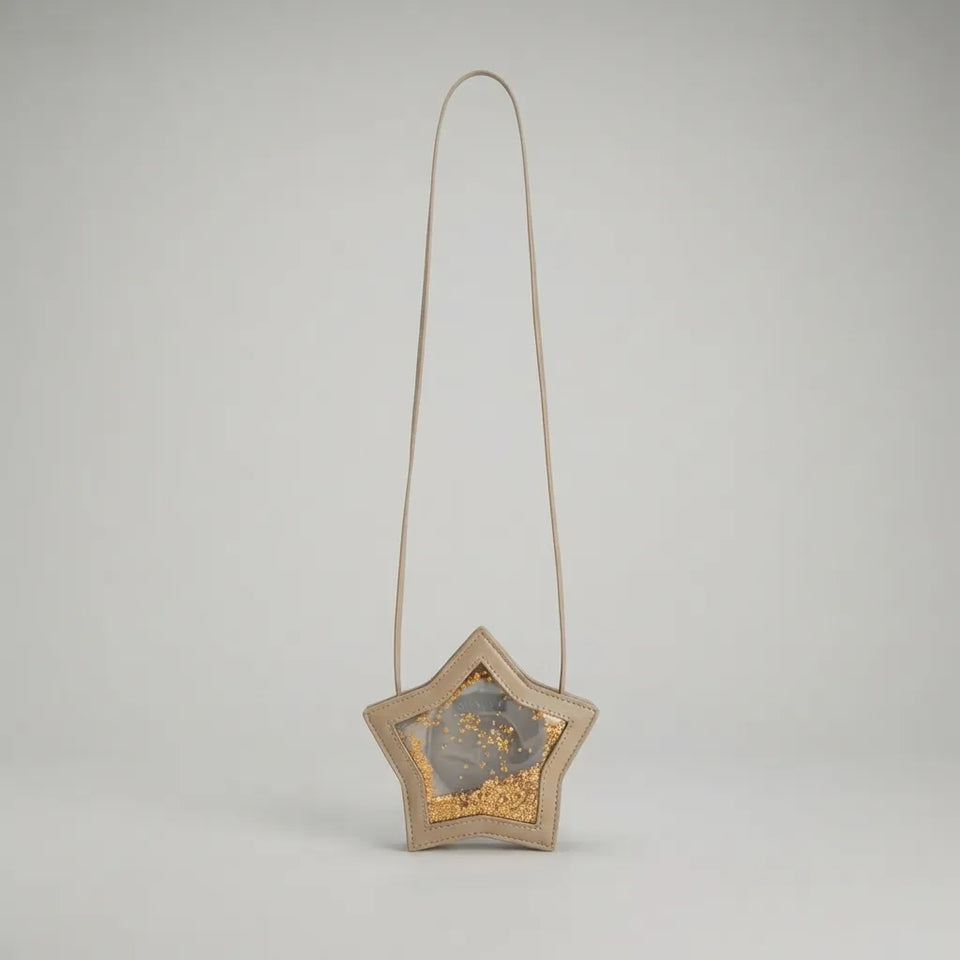 A star-shaped shoulder bag with a beige woven leather frame, a long thin strap, and a glittery gold and gray interior, shown against a neutral light gray background.