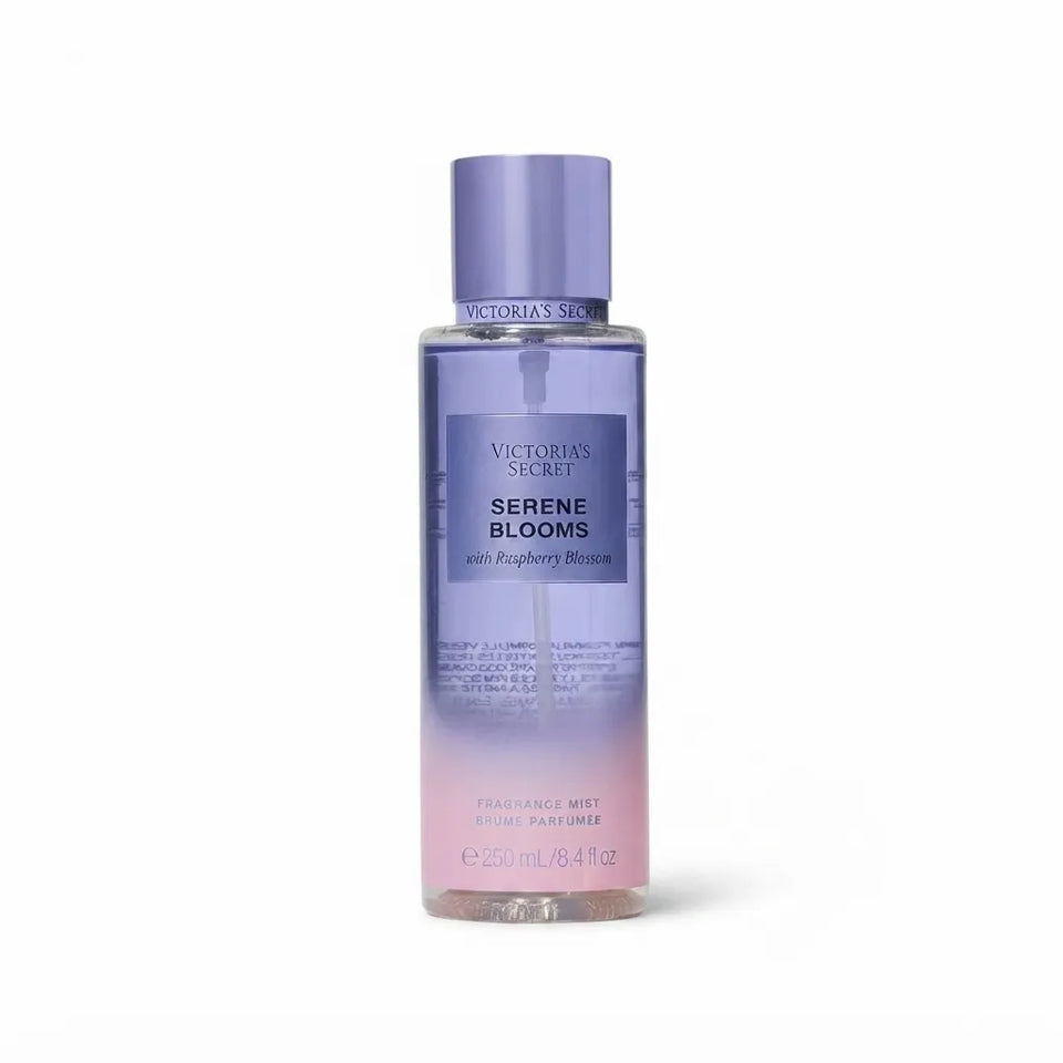 Victoria's Secret Serene Blooms Fragrance Mist in a clear bottle with a lavender-to-pink gradient label and a matching lavender cap, shown on a white background.
