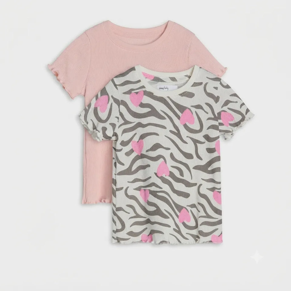 Two short-sleeve girls' t-shirts with ruffled edges, displayed as a layered set. The front shirt features a gray and white zebra print pattern with pink hearts, and the back shirt is solid light pink.