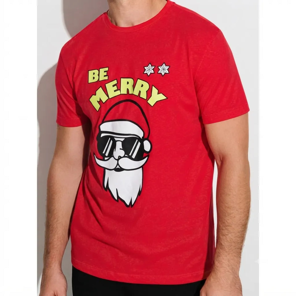 A man wearing a red crew-neck t-shirt with a 'BE MERRY' graphic featuring a Santa Claus face wearing black sunglasses.