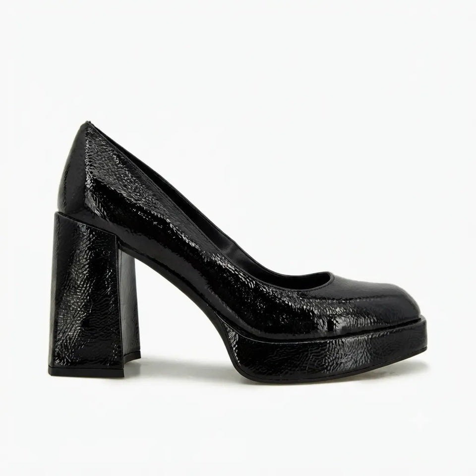 A single black patent leather pump with a chunky block heel and platform sole, shown in profile against a plain white background.