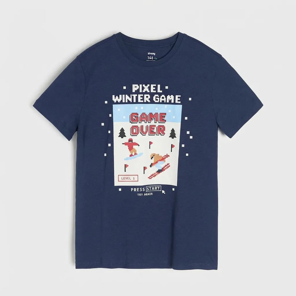 A navy blue short-sleeve t-shirt with a retro video game graphic on the front. The graphic features pixelated text reading 'PIXEL WINTER GAME' and 'GAME OVER' with a snowboarder and skiers, set against a light gray background.