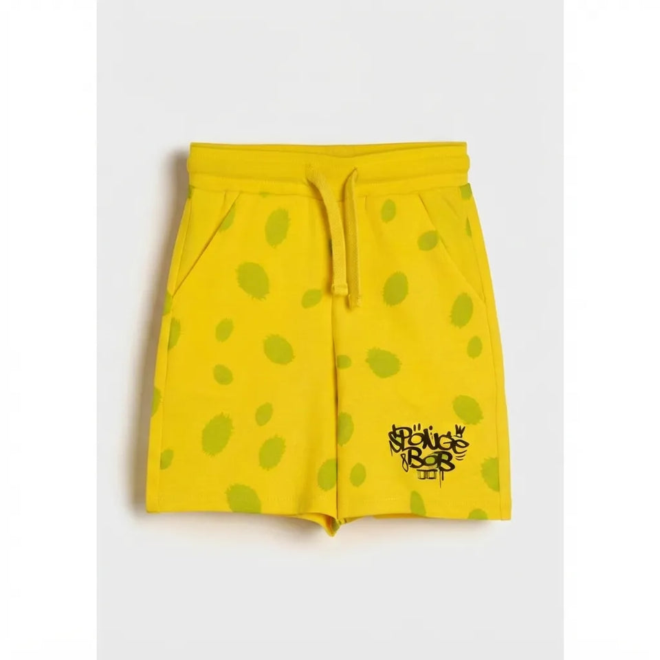 Yellow shorts with green polka dots and a black 'Bougie Rock' logo on the lower left leg, displayed flat against a light gray background.