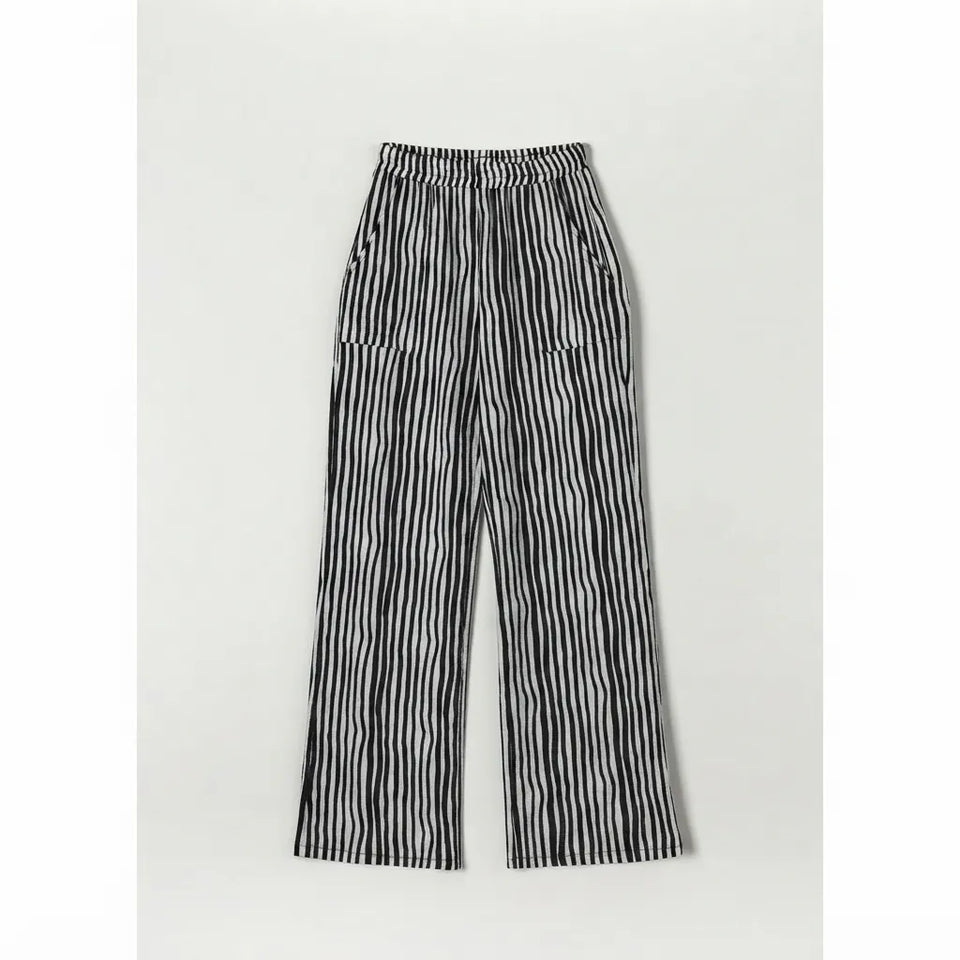 Black and white vertically striped wide-leg pants with an elastic waistband, displayed flat against a light gray background.