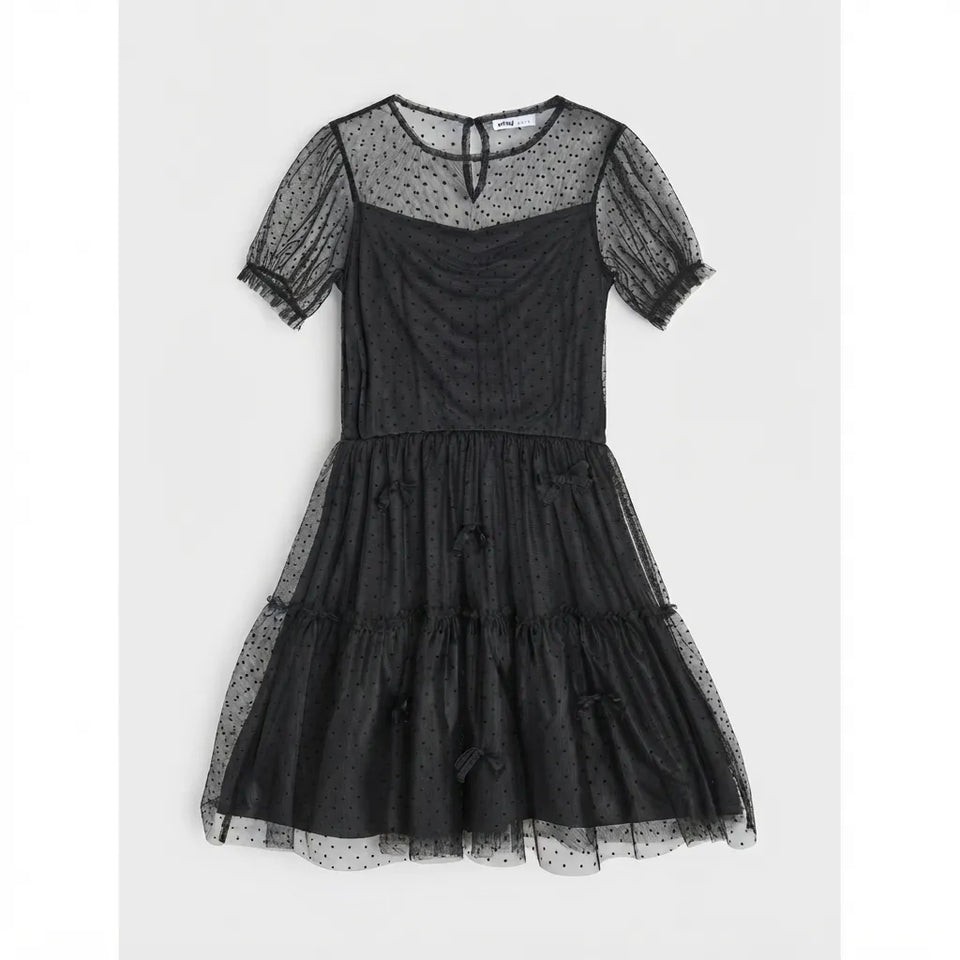 A black tiered tulle dress with sheer polka-dot short puff sleeves and a keyhole neckline, displayed flat against a light gray background.