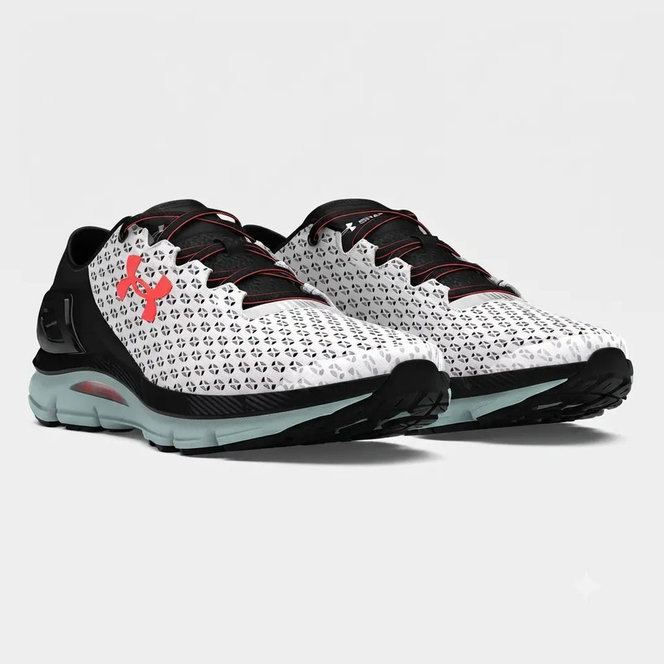 A pair of Under Armour running shoes in white, black, and red, featuring a patterned upper, black laces, and a red Under Armour logo on the side, set against a light gray background.