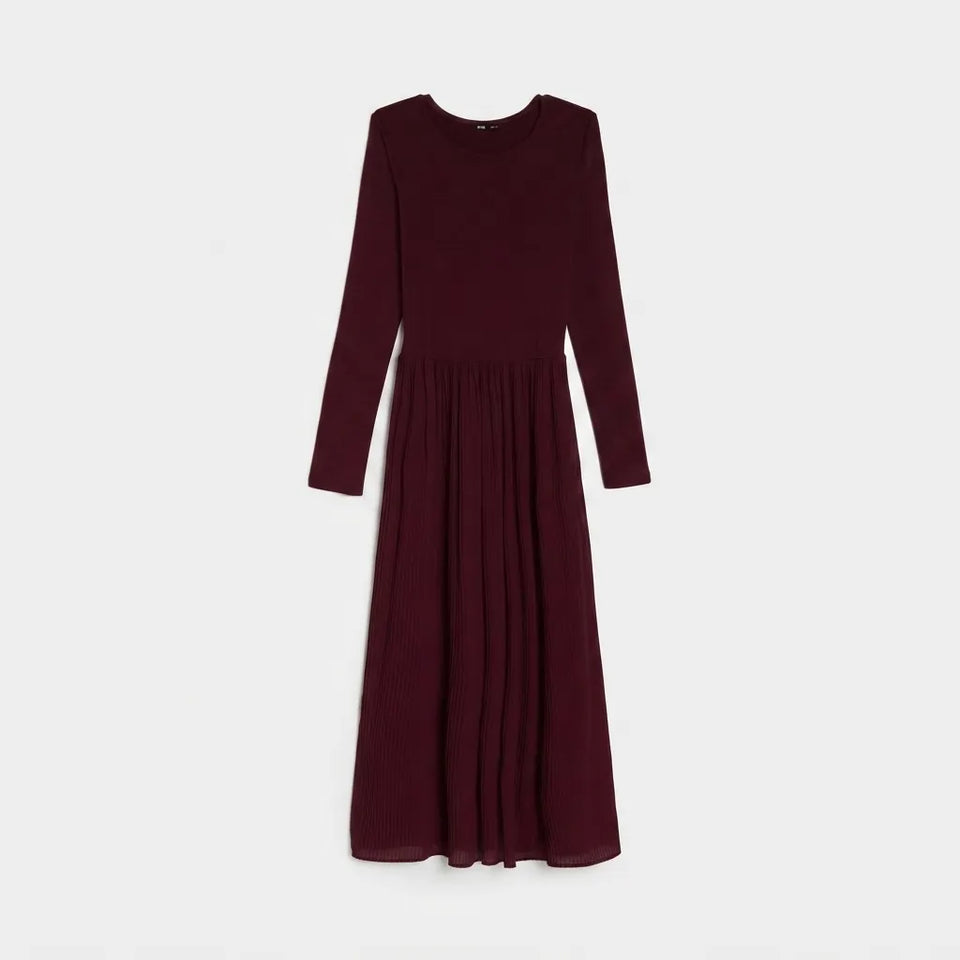 A long-sleeve midi dress in deep burgundy, featuring a round neckline and a pleated skirt, shown against a plain light gray background.