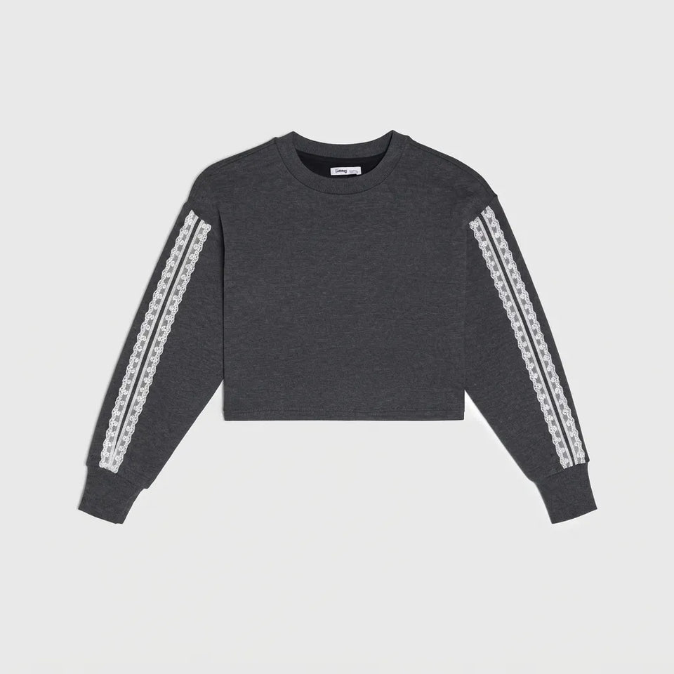 A dark gray cropped crewneck sweatshirt with white patterned knit stripes down both sleeves, displayed flat against a light gray background.