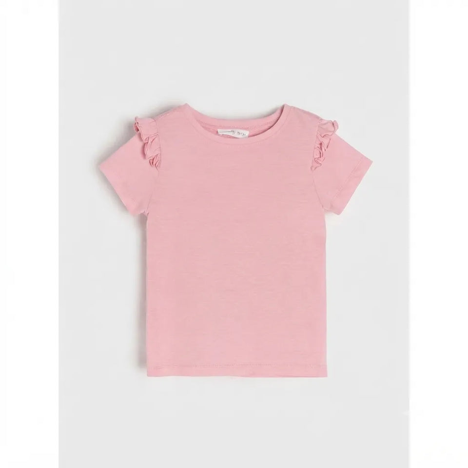 A light pink short-sleeve baby tee with delicate ruffle details on the shoulders, displayed flat against a light gray background.