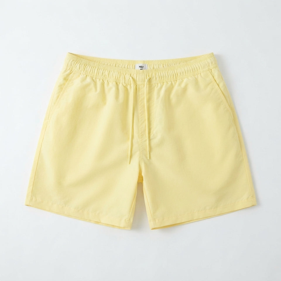 Light yellow drawstring shorts laid flat against a clean white background.