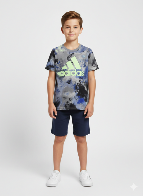 Child wearing an Adidas t-shirt with a tie-dye design and navy shorts on a white background