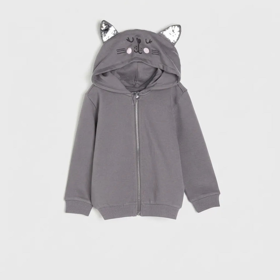 A gray children's zip-up hoodie with a cat-themed hood featuring sequined ears, embroidered facial details, and a front zipper, shown against a light gray background.