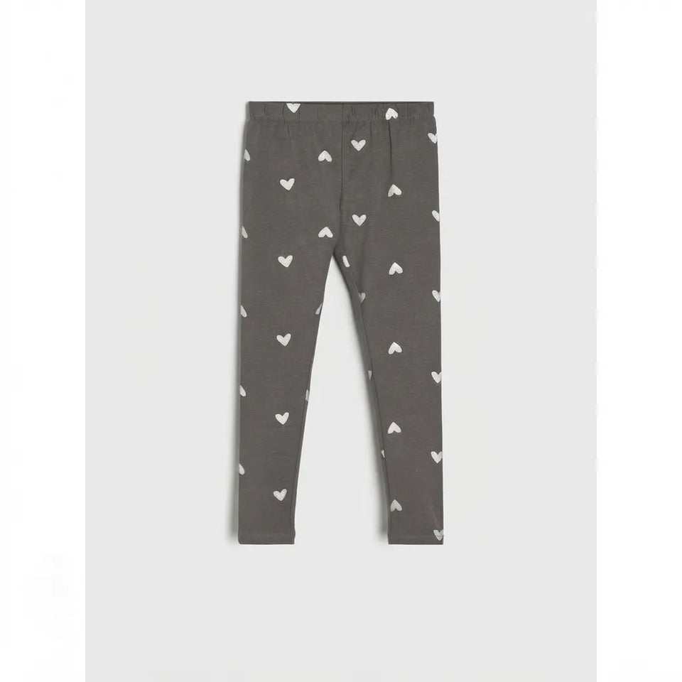 A pair of dark gray leggings with a small white heart pattern, displayed flat against a light gray background.
