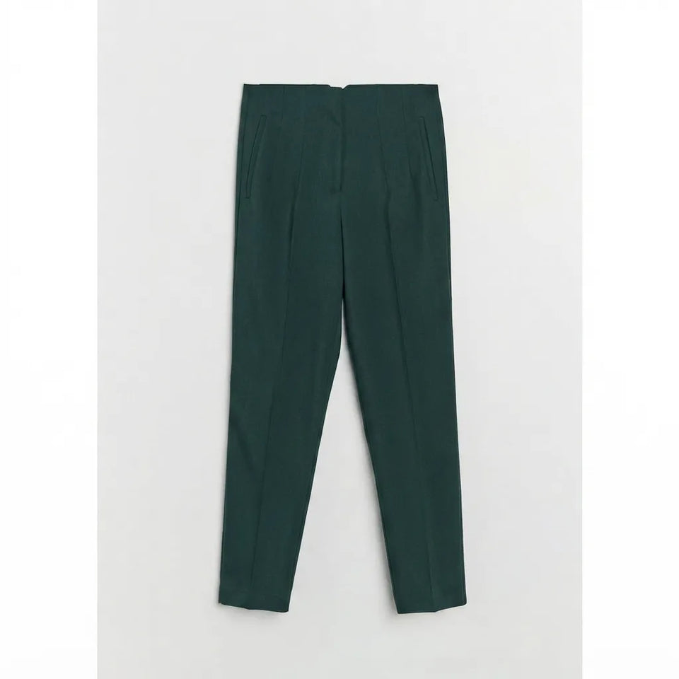 A pair of dark forest green trousers laid flat against a light gray background.