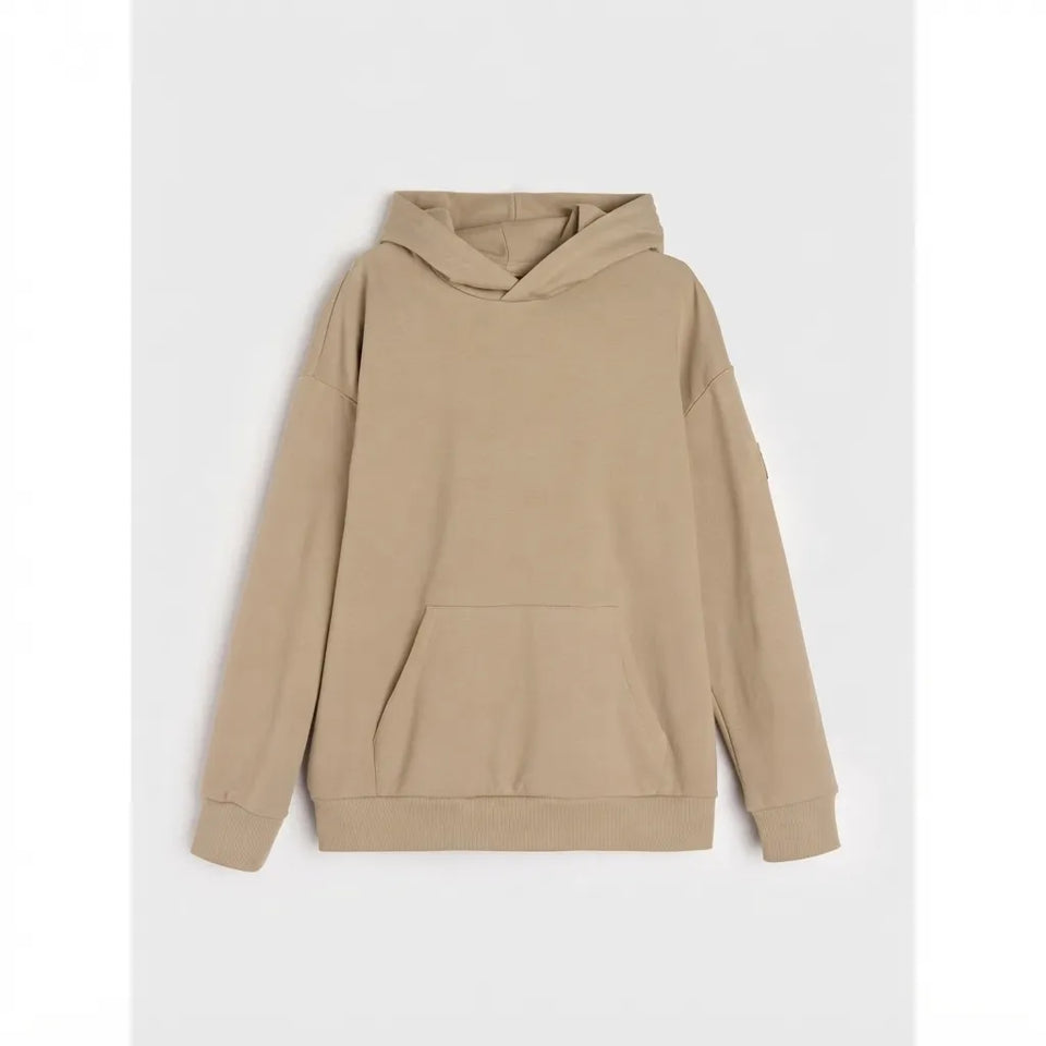 A plain beige pullover hoodie with a kangaroo pocket, shown flat against a light gray background.