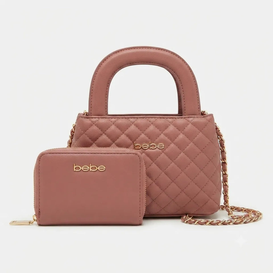 A dusty rose quilted handbag with a top handle and a matching zip-around wallet, both featuring gold-tone 'bebe' branding and a gold chain strap, set against a light gray background.