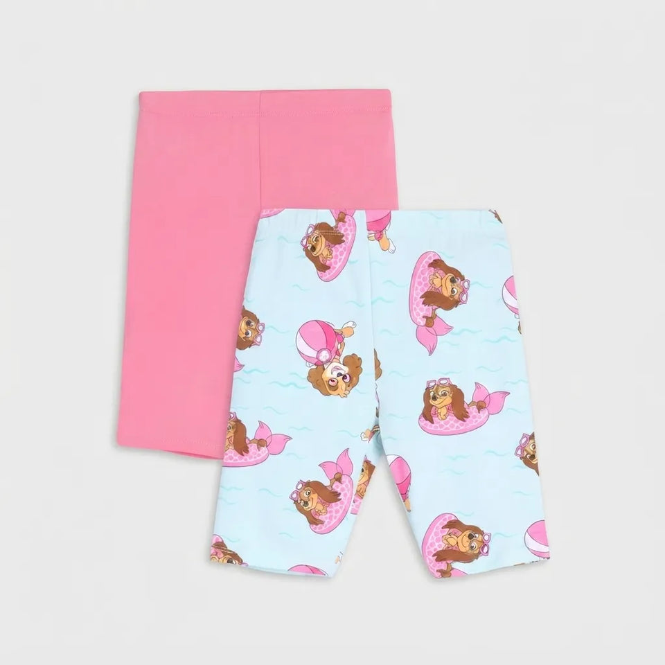 A pair of toddler leggings shown flat on a light gray background, featuring a light blue and pink mermaid pattern with a cartoon girl in a pink float, with a solid pink pair of leggings folded behind them.