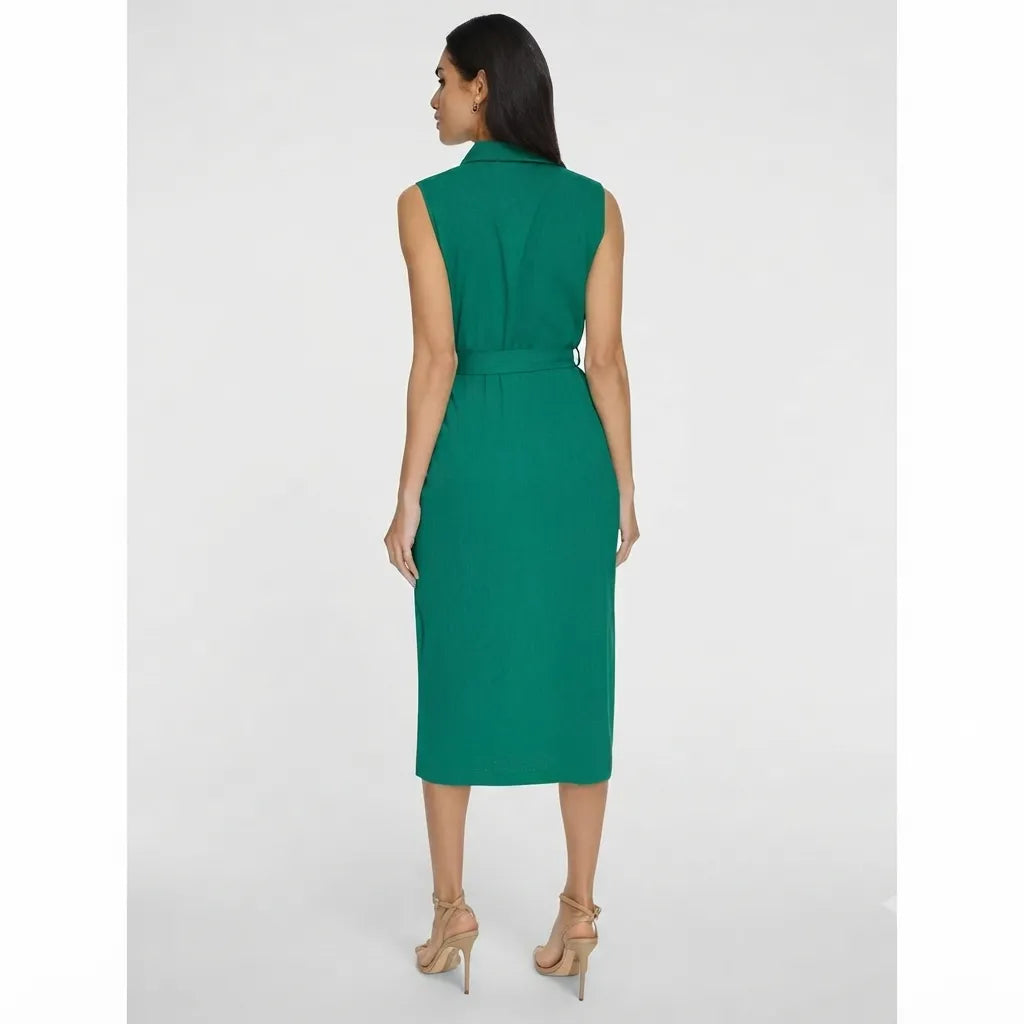 A woman wearing a sleeveless emerald green midi dress with a collar and tie waist, shown from the back against a light gray studio background.