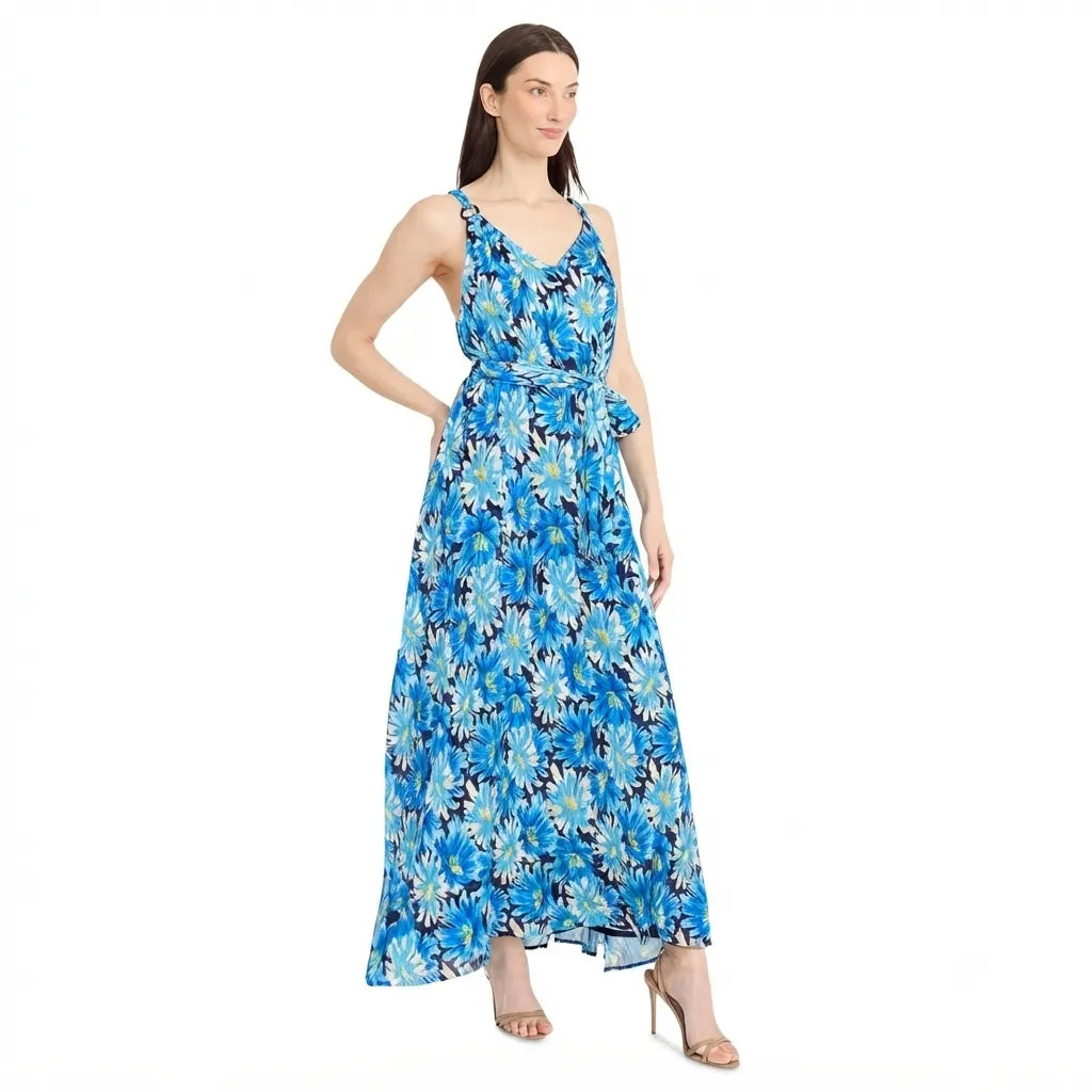 A woman modeling a sleeveless, V-neck maxi dress with a blue, white, and black floral pattern, set against a plain white background.