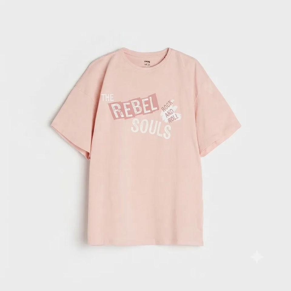 A light pink short-sleeve t-shirt with a graphic print on the front reading 'THE REBEL SOULS' in white and dark pink, displayed against a light gray background.