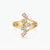 A gold ring with four marquise-cut pastel gemstones in pink, light green, light blue, and pink, set against a clean white background.