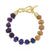 A beaded bracelet featuring faceted gemstone beads in purple, blue, and peach-orange tones, separated by small gold spacer beads and finished with a gold toggle clasp, shown on a plain white background.