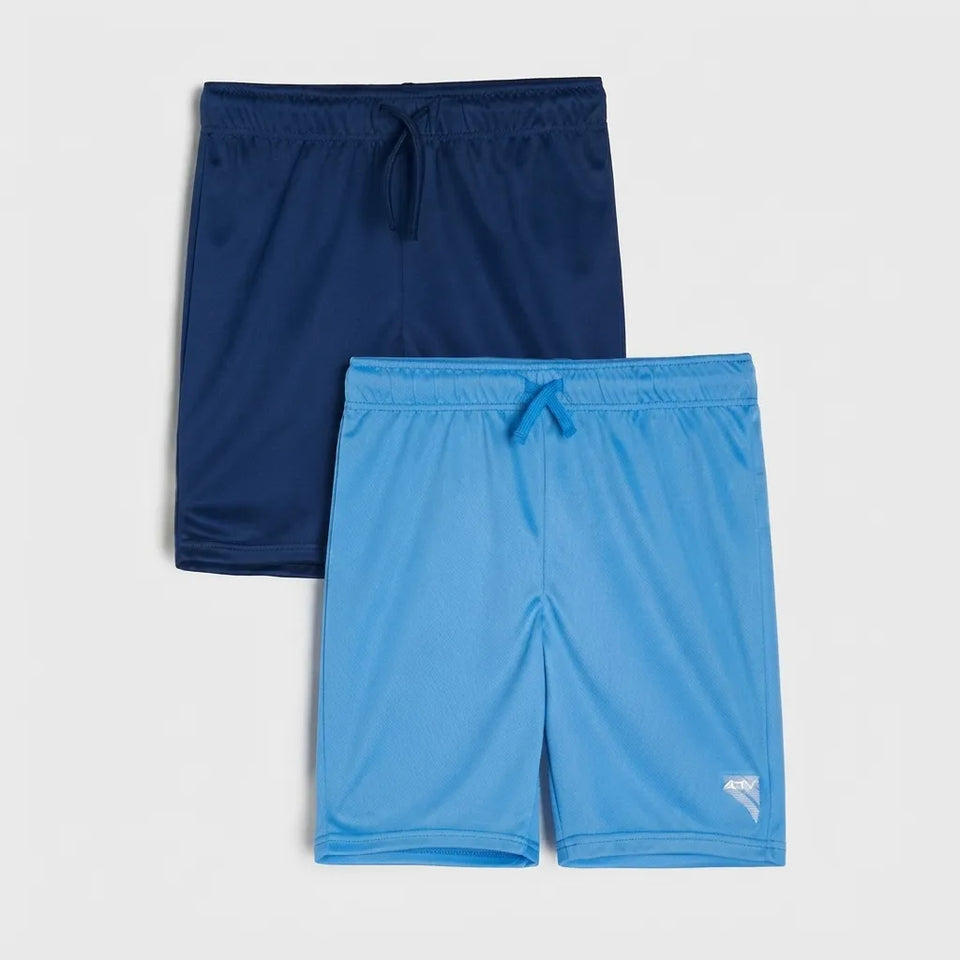 Two pairs of athletic shorts, one in navy blue and one in light blue, displayed flat against a light gray background. The light blue pair features a small white logo on the lower left leg.