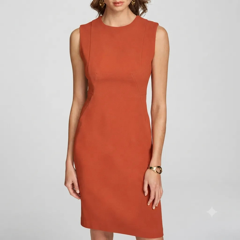 A woman wearing a sleeveless, knee-length orange-red sheath dress against a light gray studio background.