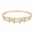 Gold band ring with five floral clusters featuring round milky white cabochons and marquise-cut clear stones, with 'ANNE KLEIN' engraved inside the band.