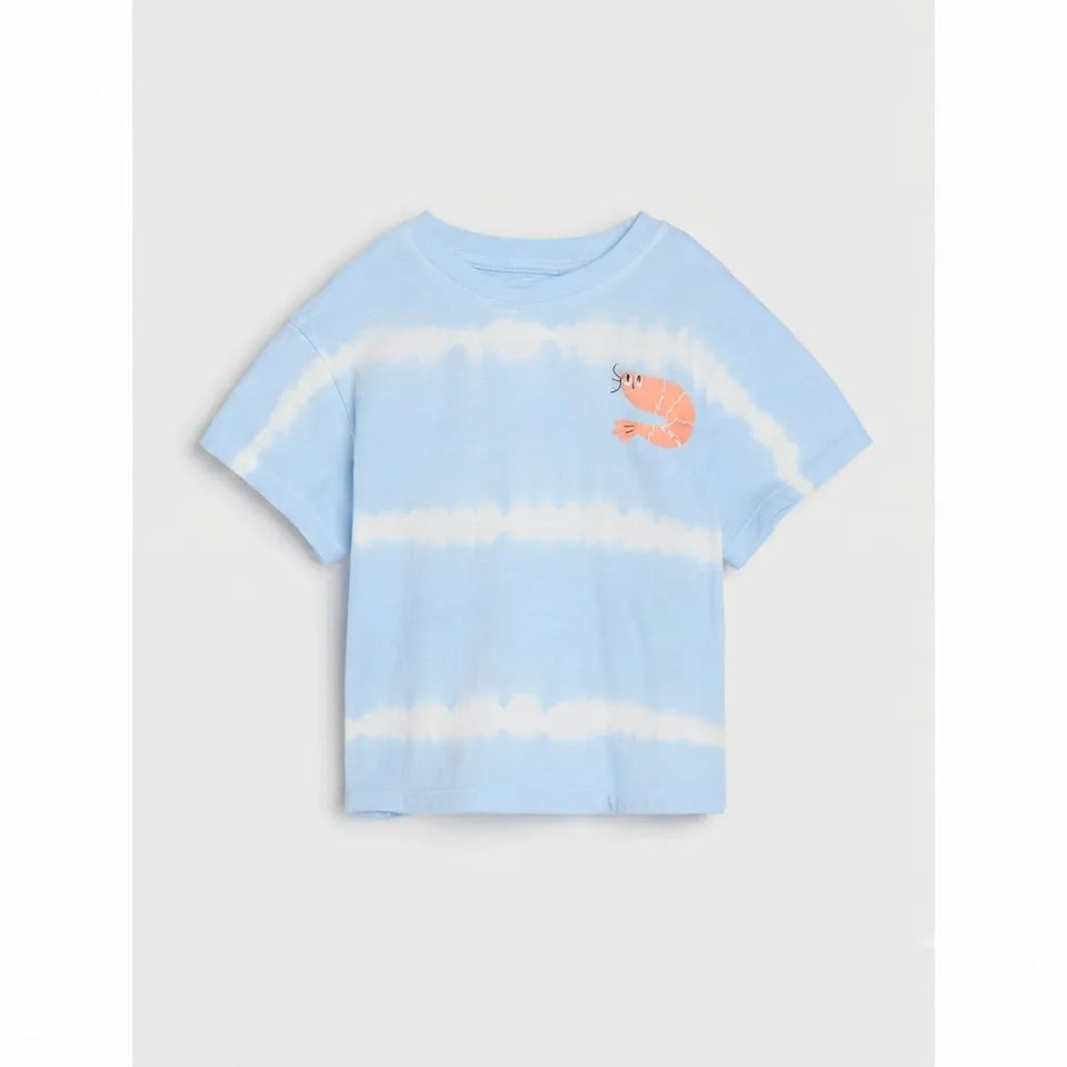 A light blue and white tie-dye short-sleeve t-shirt featuring a small orange shrimp graphic on the left chest, displayed against a neutral light gray background.