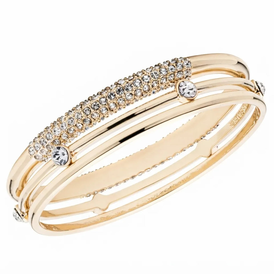 A gold-plated triple-band ring featuring a top band paved with small clear cubic zirconia stones and accented with three round-cut clear stones, shown on a white background.
