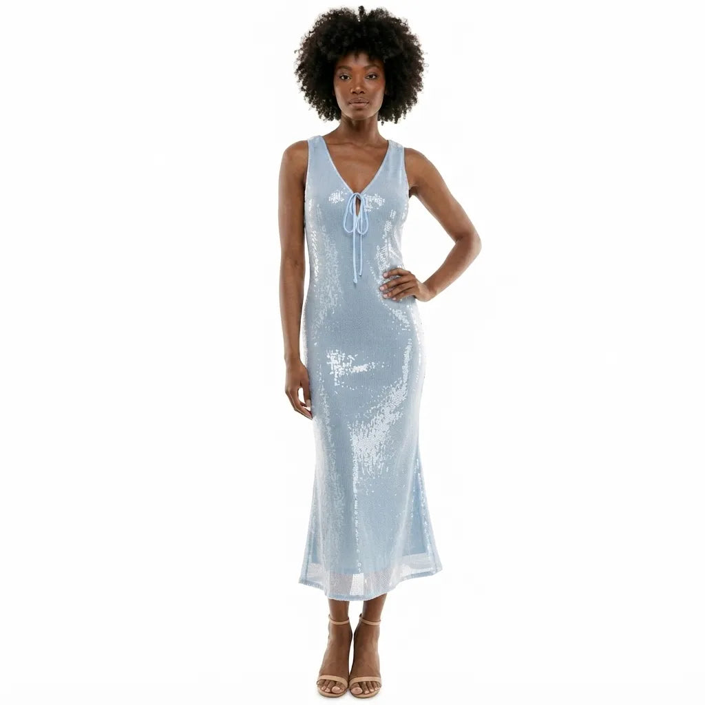 A woman modeling a light blue sequined sleeveless maxi dress with a tie-neck detail, set against a plain white background.
