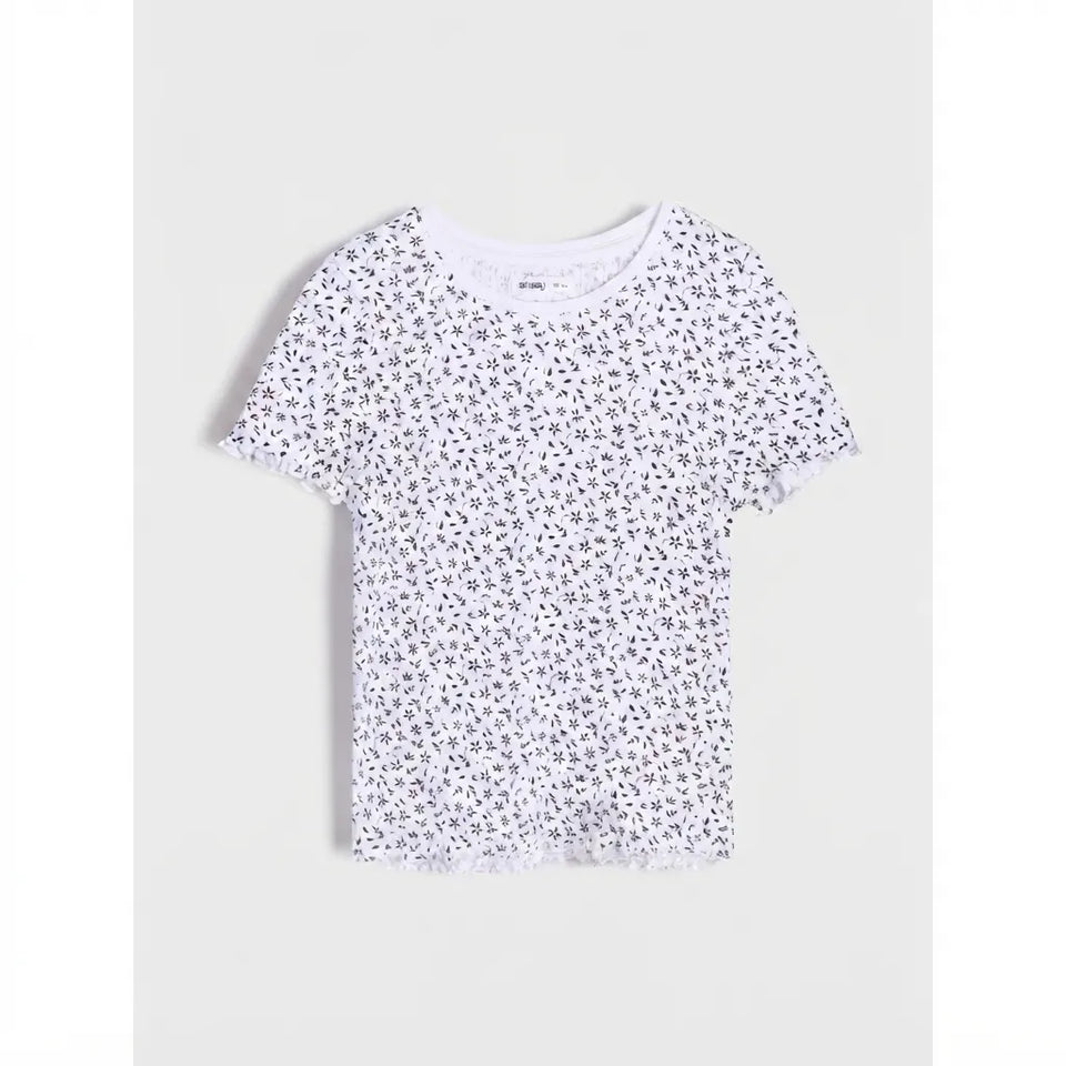 A white short-sleeve t-shirt with a dense, all-over black floral print, displayed flat against a light gray background.