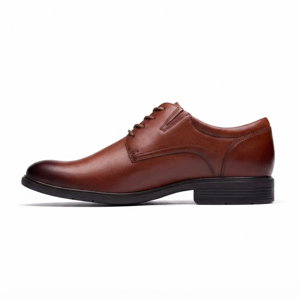 A single men's brown leather oxford shoe with a low stacked heel and black sole, shown in a side profile on a white background.