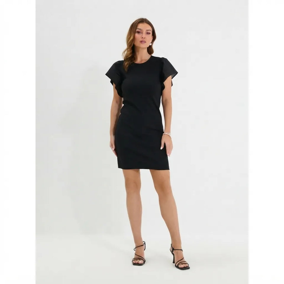 A woman modeling a black short-sleeve bodycon mini dress with flutter sleeves, paired with black strappy high-heeled sandals, against a plain white studio background.
